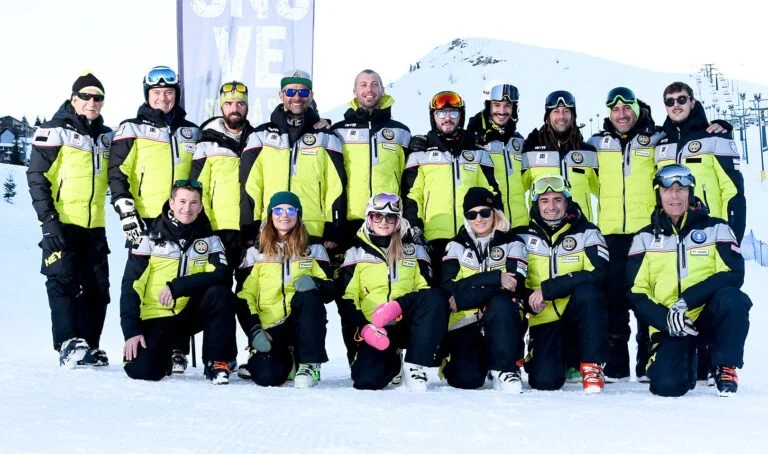 I maestri della Scuola Sci Zeronove in divisa gialla e nera, in posa sulla neve